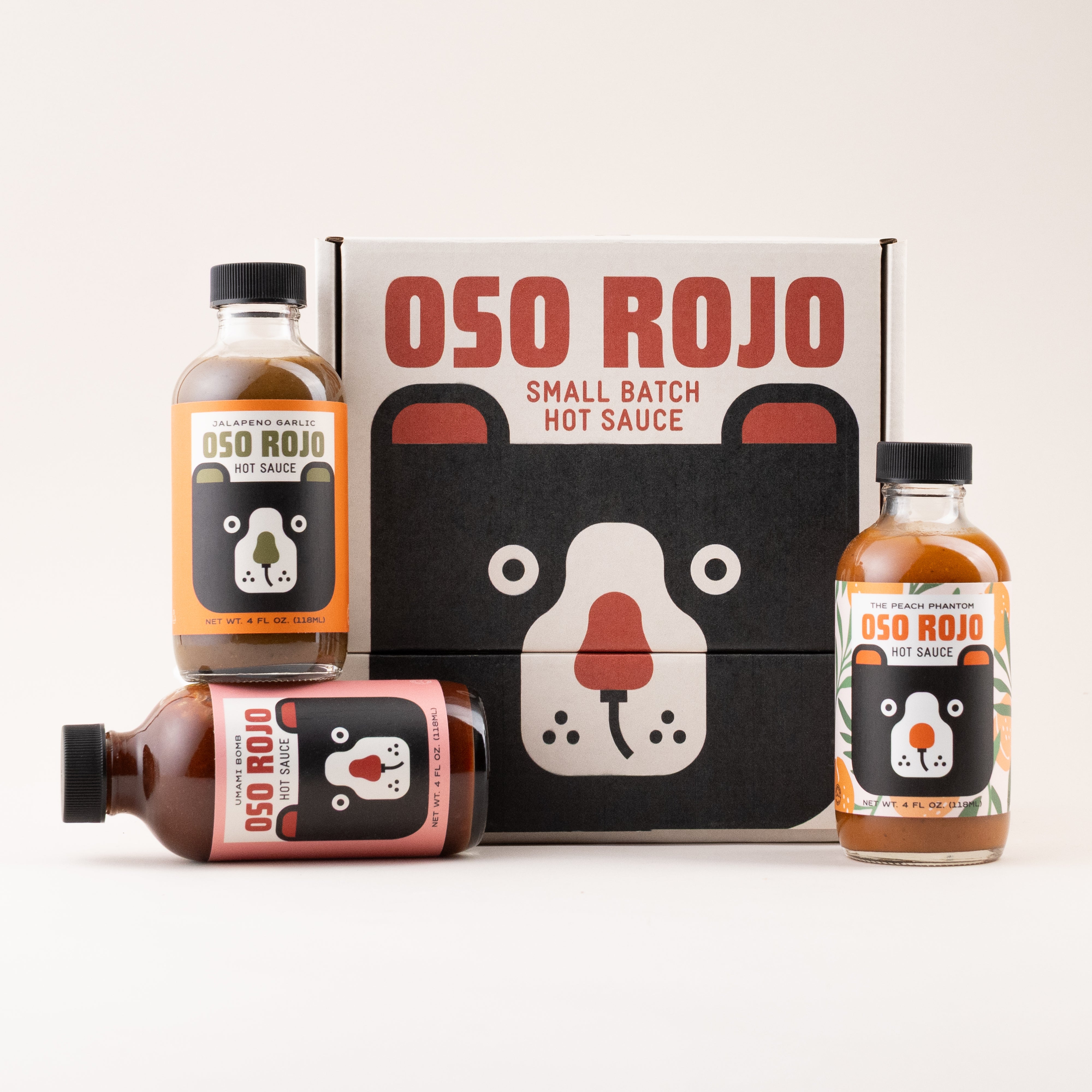 Oso Rojo hot sauce bottles and gift box packaging on a white background